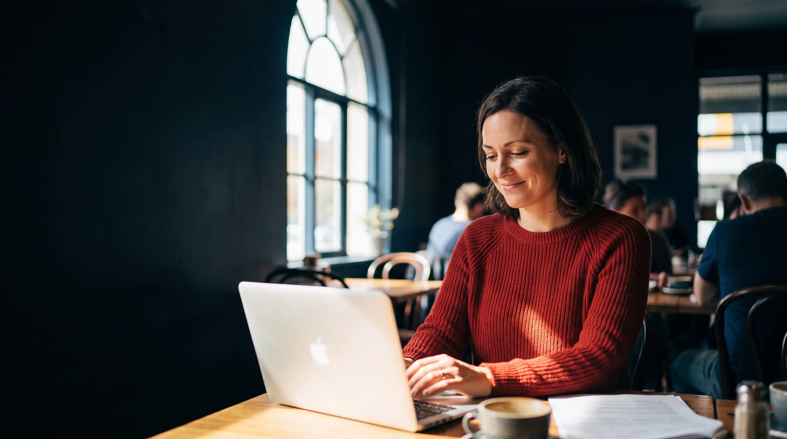 Melbourne small-business owner reviewing search results on her laptop at a café