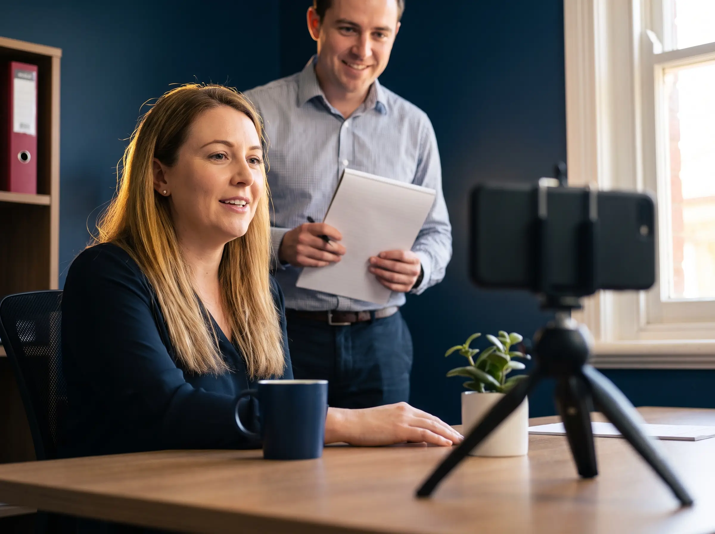 Two colleagues in an accounting practice recording a short spoken answer to a client question.
