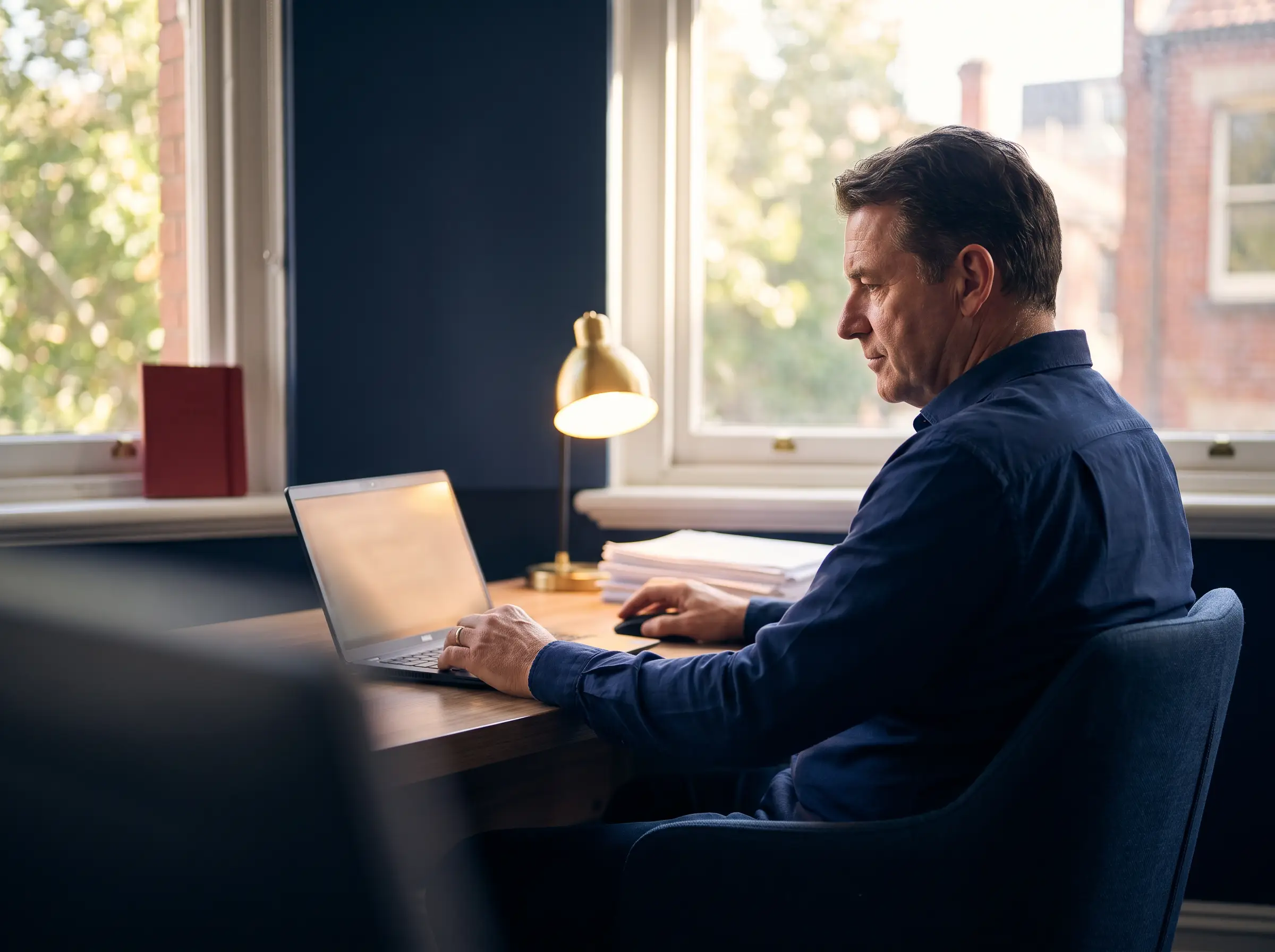 A practice partner at a laptop reviewing a website performance dashboard
